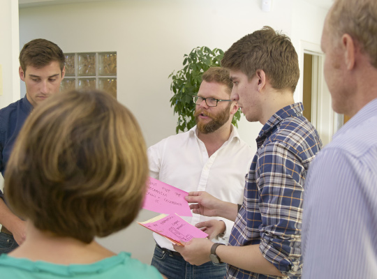 group of people in stand up meeting