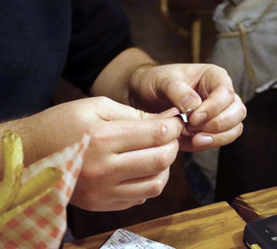 hands opening test strip at table