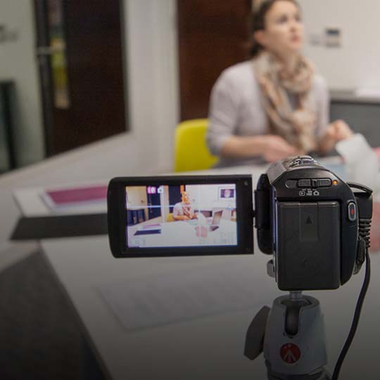 hand held camera with screen filming human factors consultant conducting a study