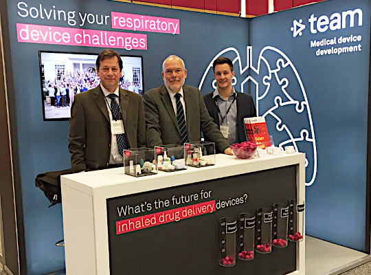 three people at team consulting stand