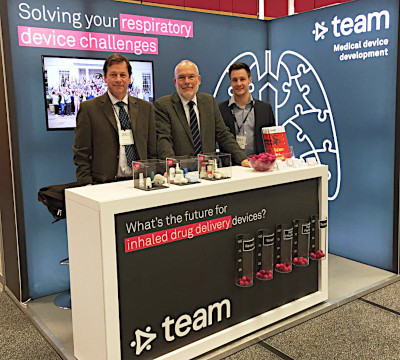 three people at team consulting stand