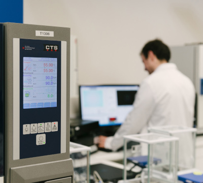 laboratory with test equipment and person in white coat in background